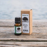 Balsam Fir Essential Oil Bottle with Balsam Fir Essential Oil Box sitting on a wood plank