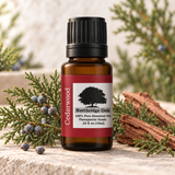 Northridge Oak Cedarwood Essential Oil bottle with cedar foliage, seed cones, and natural wood