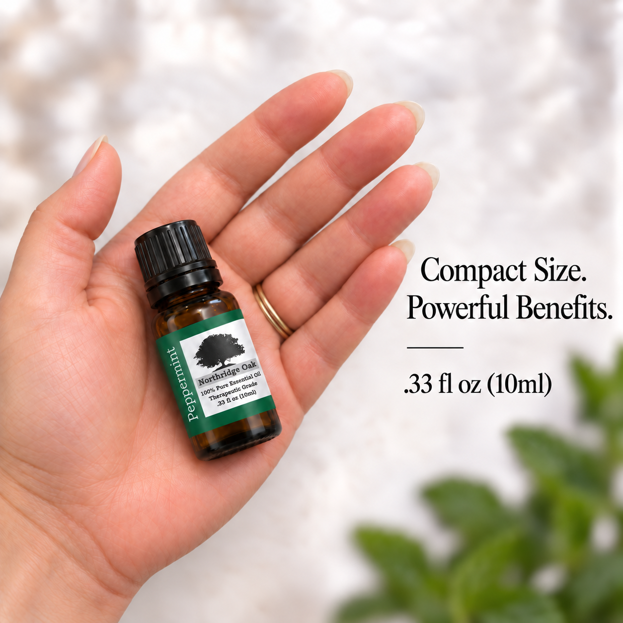 Northridge Oak Peppermint Essential Oil 10 mL bottle shown in an open palm for scale